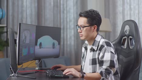 smiling man working on car design software at home