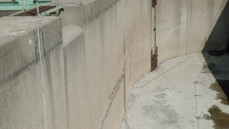 panning up from a concrete water reservoir on chaudière island that is part of the hydro electric dam to reveal the chaudière bridge and construction of downtown hull in quebec