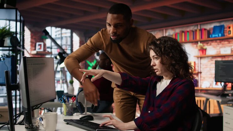 Startup office chief technology officer overseeing woman building application