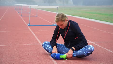 Female-athlete-relaxing-on-a-running-track-4k
