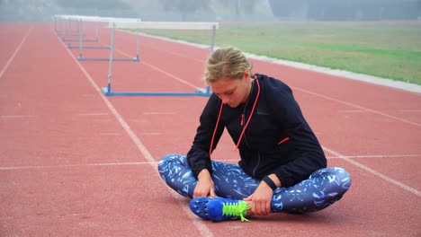 female athlete relaxing on a running track 4k