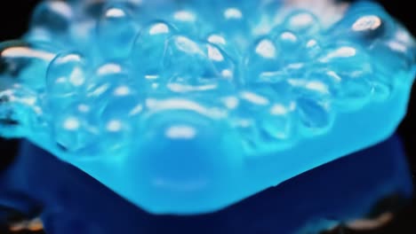 a close-up exploration of a vibrant blue soap bar transitioning from a solid to a fluid surface, capturing the unique details and textures in stunning clarity