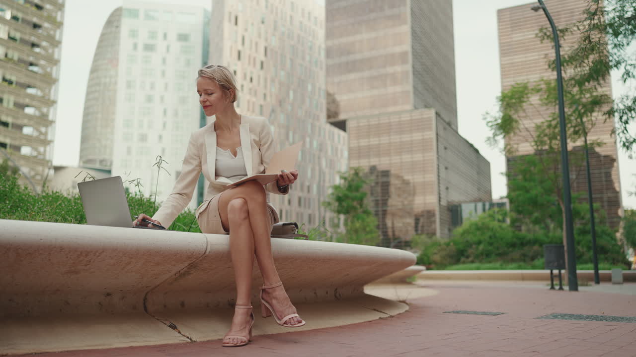 Businesswoman working on laptop in the city