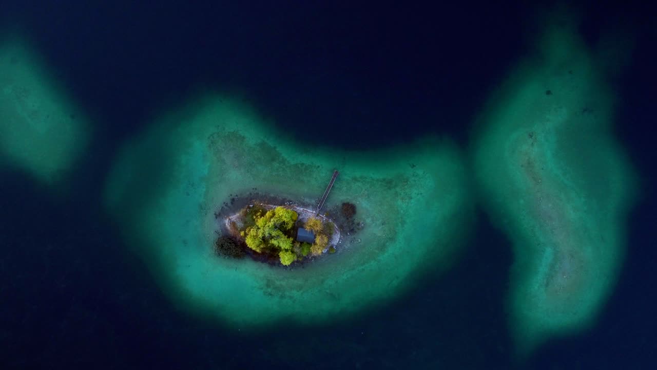 Aerial View of a Secluded Island in a Turquoise Lake