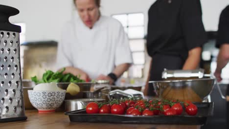 caucasian female chef teaching diverse group