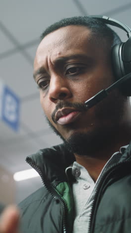 man wearing headphones in an office setting