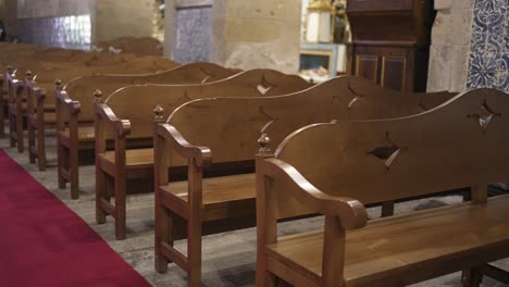 rows of empty wooden pews in a church