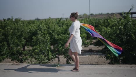 woman walking with rainbow pride flag