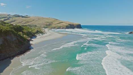 aerial view of ocean swell, rips and waves with sand dune coastal landscape at smails beach on the otago peninsula, dunedin, new zealand aotearoa