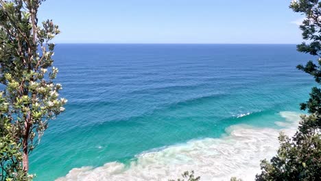 a tranquil glimpse of the sea between foliage.