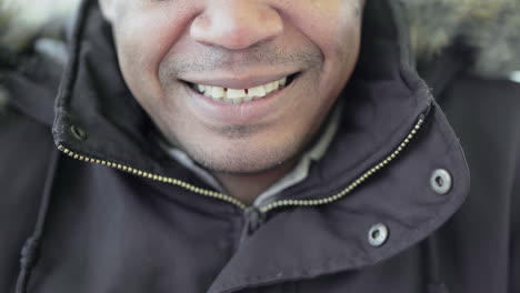 close up shot of afro-american middle-aged mans mouth biting lips slightly and smiling