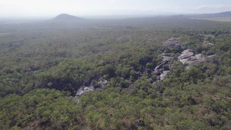 green trees and granite boulders at granite gorge nature park in north queensland, australia - aerial panoramic