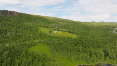 Approaching-Isolated-Architecture-Amidst-Green-Forest-Mountains-In-Norway,-Europe