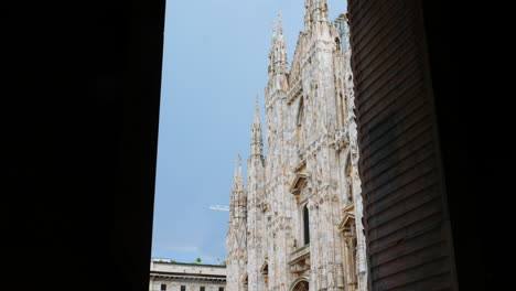 Duomo-in-Milan,-a-famous-attraction-seen-through-a-entrance