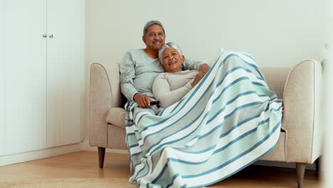 Senior-couple,-relax-and-watching-tv-on-sofa