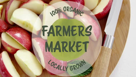 100 percent organic farmers market locally grown animation over sliced apples on wooden board