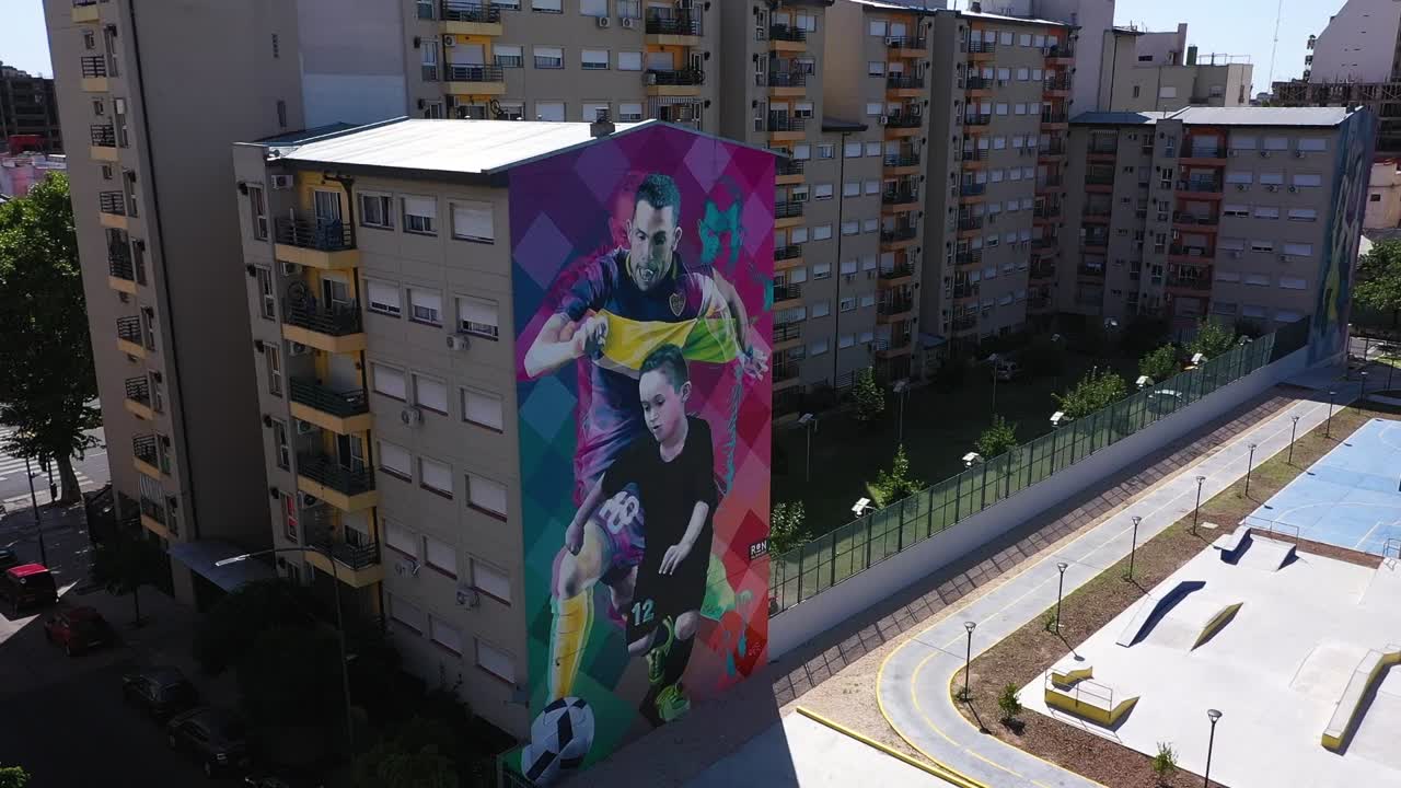 Carlos Tevez And Young Boy Mural On Wall Of Building At LOS CAMPITOS Public Park In La Boca, Buenos Aires, Argentina. - aerial