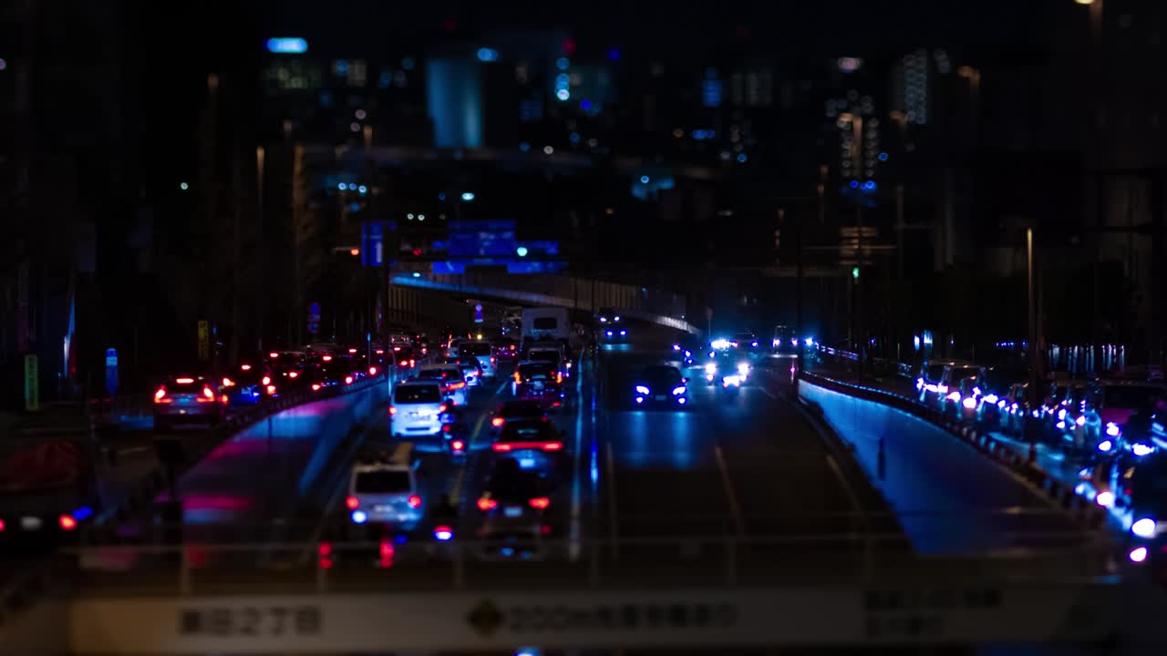 En natt-timelapse av et miniatyrkork i en bygate i Tokyo