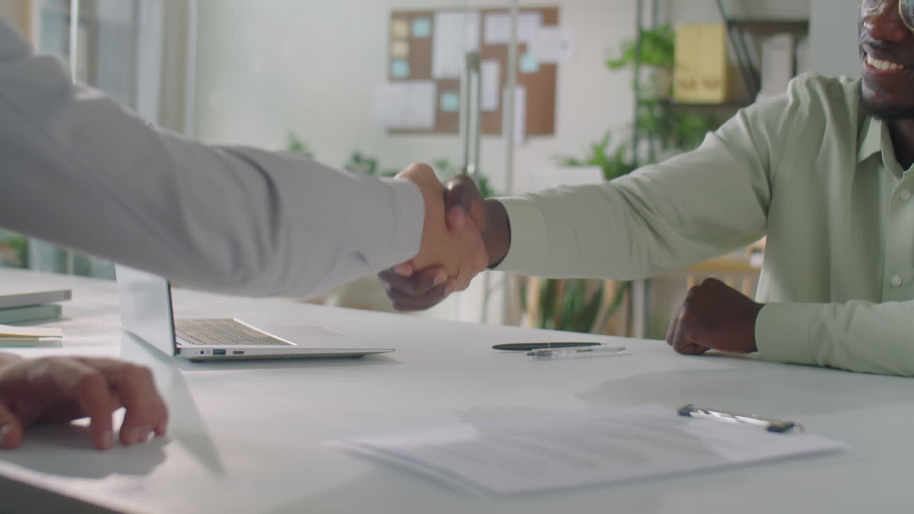 Businessman Shaking Hands with Partner in Office