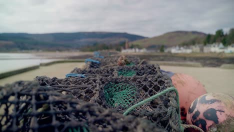 a commercial fishing buoys and fishing nets on the beach waiting to be used next by fisherman