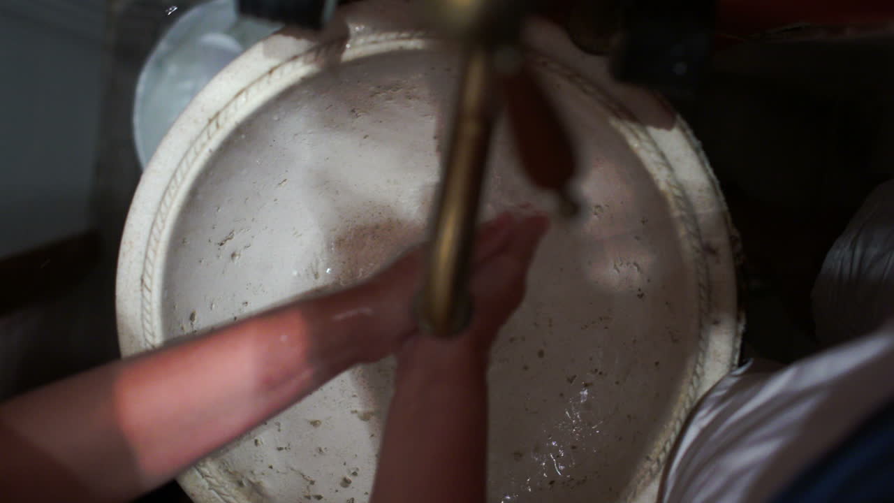 Woman washing hands in old vintage sink