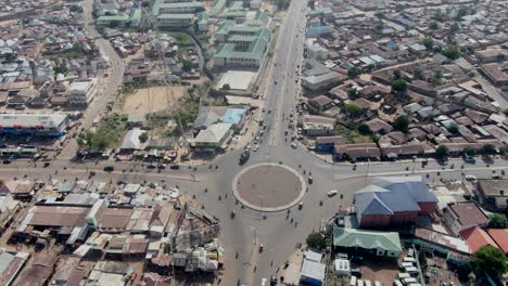 roundabout intersection with car and motorcycle traffic in gombe, nigeria - aerial orbit