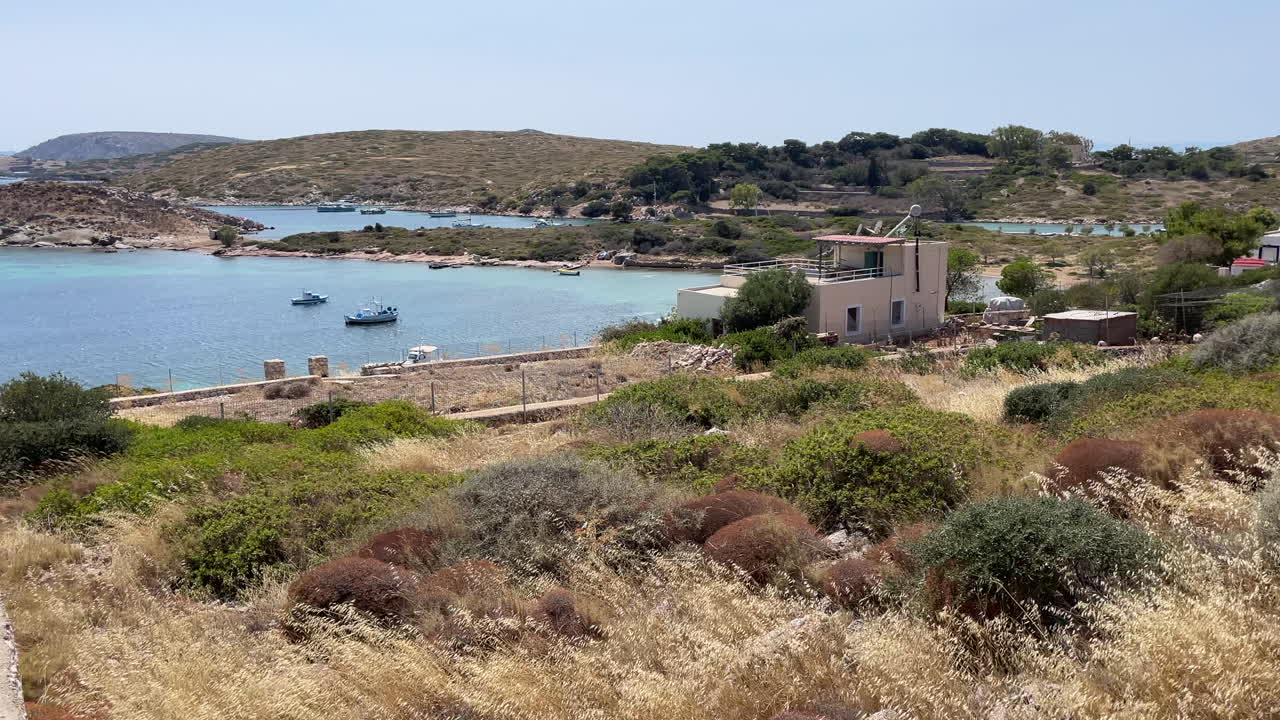 Greece, Arki Island, Porto Stretto, beautiful bay view, boats anchored , deep blue and turquoise sea, small islands.