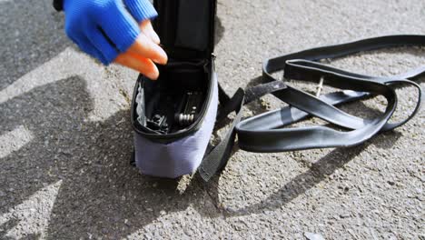 Senior-cyclist-using-air-pump-on-a-road-4k