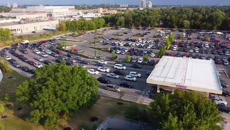 drone shot of cars and trucks in line up at gas station during pandemic fuel shortage