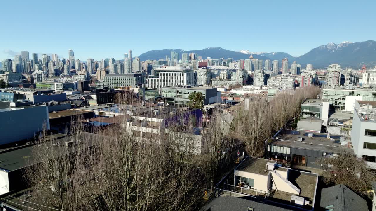 Harbour Centre And Waterfront District Of Downtown Vancouver From Building Roofdeck In Fairview, Vancouver, Canada. drone shot, ascending reveal