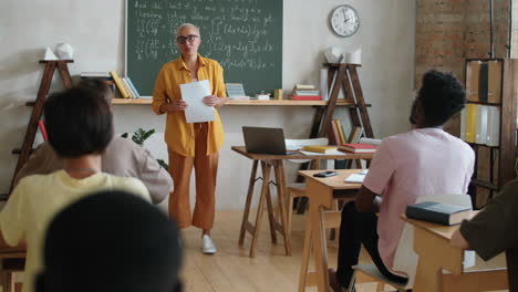 female teacher giving lesson to multiethnic college students