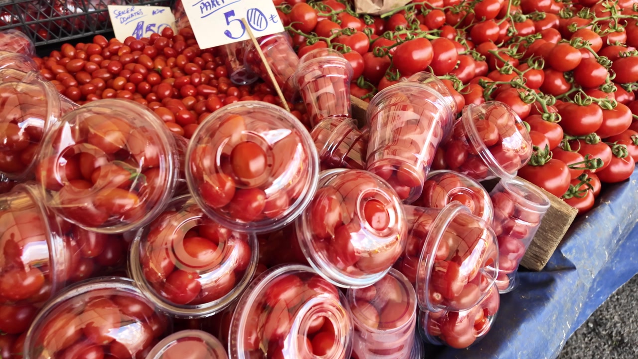 Fresh Red Cherry Tomatoes in Packages at a Farmers Market