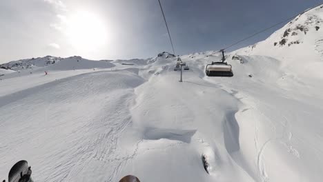 Female-Snowboarder-on-Ski-Lifts-Above-Snowy-Mountains---POV-Group-Snowboarding-Down-Ski-Slope-in-6K-|-Insta360