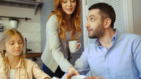 wife serving coffee to her husband