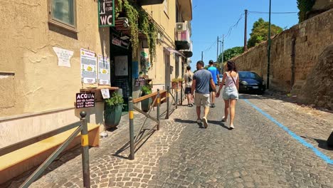 a couple walks down a sunny naples street