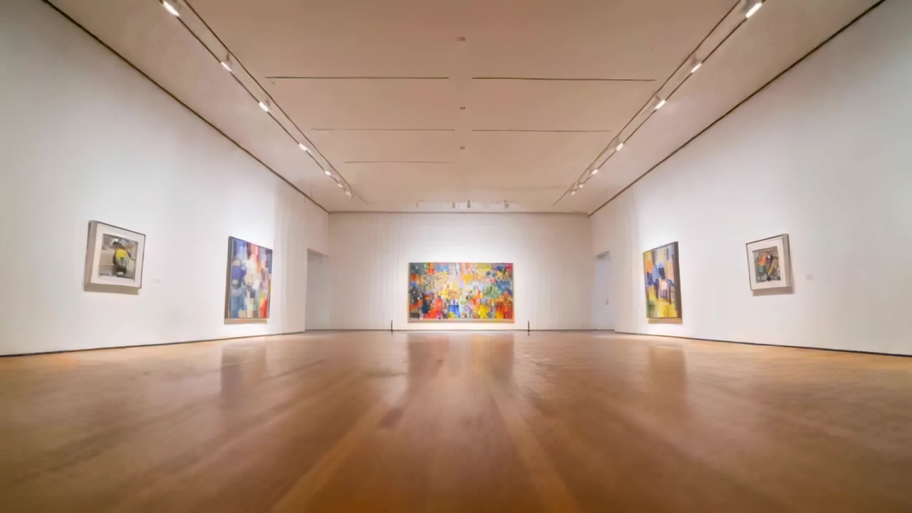Dollying low-angle camera approaching far wall at museum gallery, revealing central colorful mural