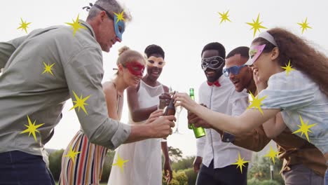 animation of christmas stars over diverse friends wearing masks at party and making toast