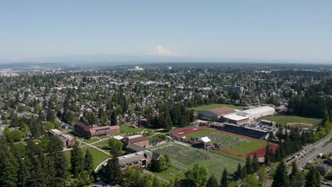 aerial view of city buildings and graduation ceremony in the field of university of puget sound in tacoma, washington