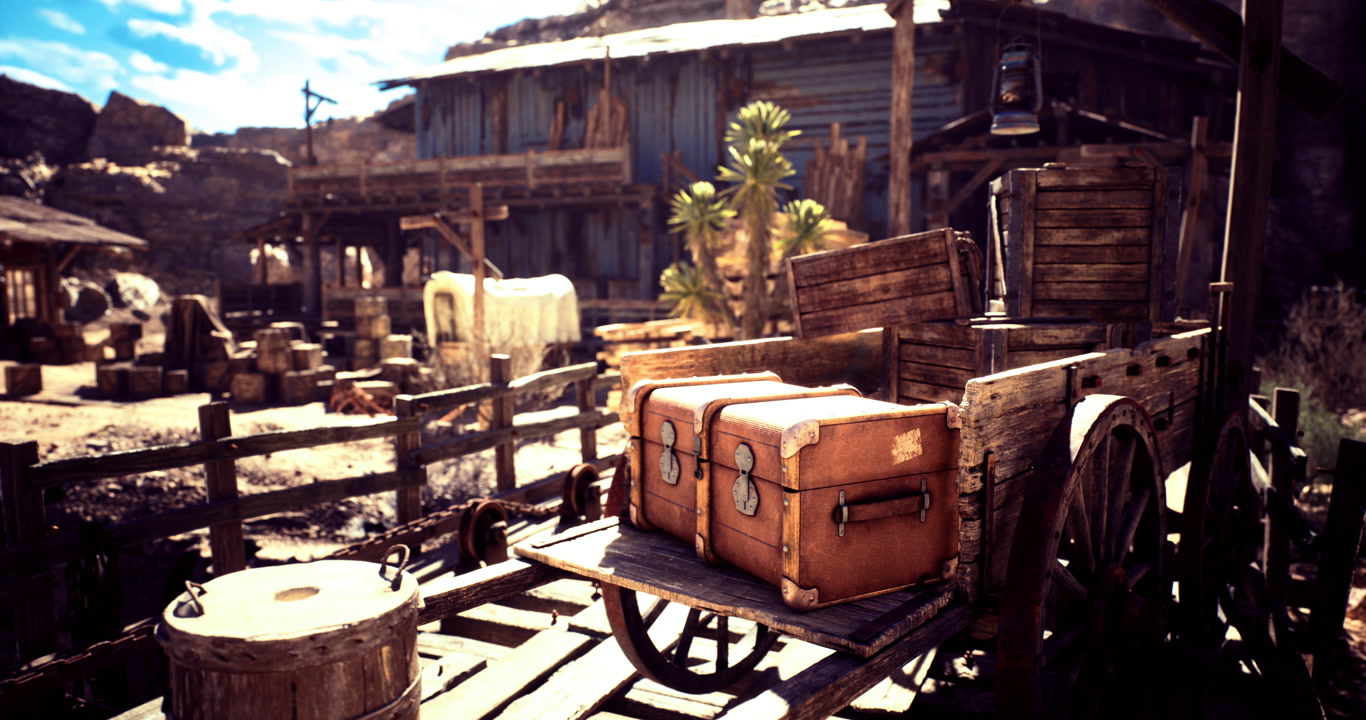 Rustic wooden wagon loaded with vintage luggage in a desert town