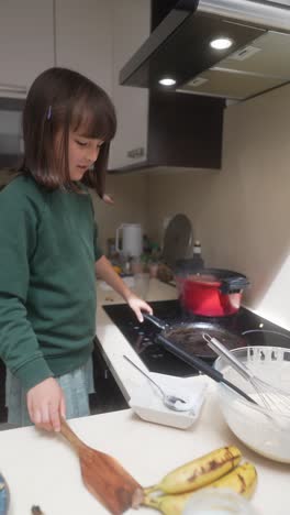 a child cooking in the kitchen