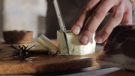 cutting cheese on a wooden  board