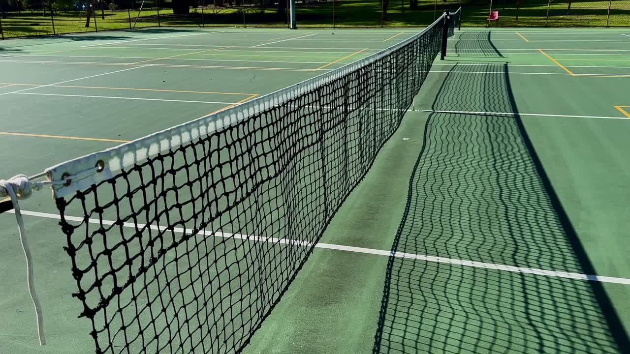 Tennis court closeup net down line of multiple courts Perth Australia