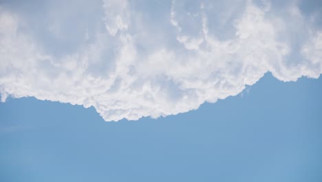 4k time lapse clouds moving in upper part of frame on blue clear sky