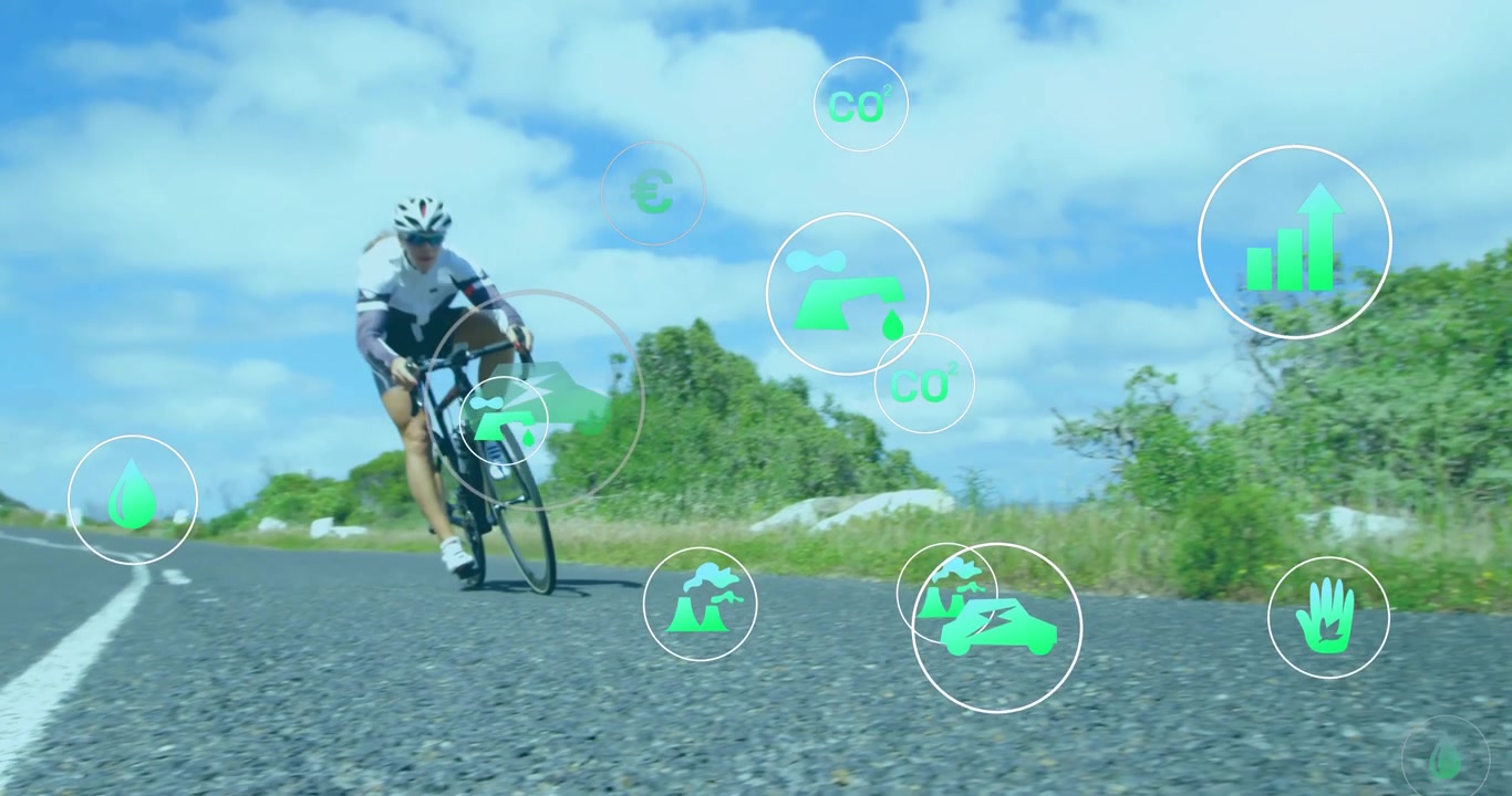 Cyklist som trampar mot kameran på vägen och aktiverar ekoinfografik som belyser ekologiska mätvärden