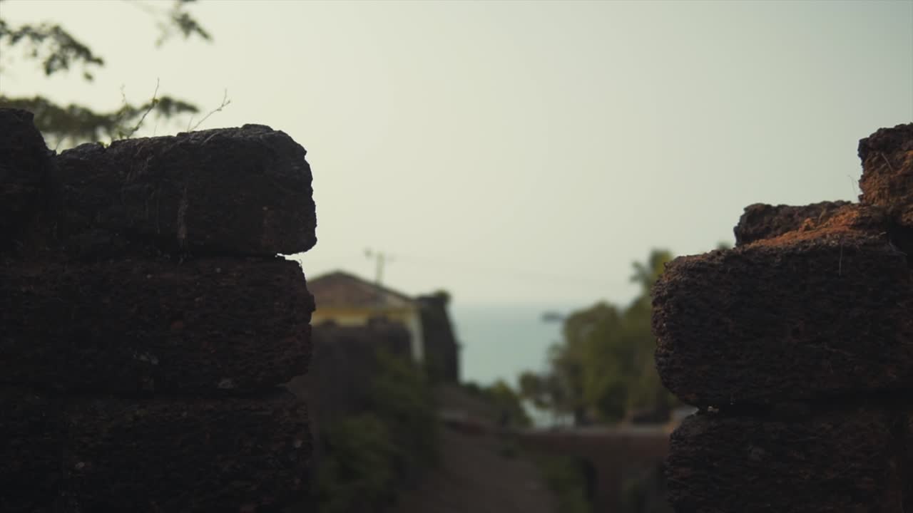 View to the Ocean Between the Bricks of an Ancient Fortress