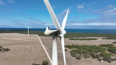 Stationary-drone-shot-of-spinning-wind-turbine