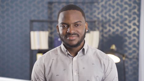 African-businessman-looking-at-camera-and-laughing.