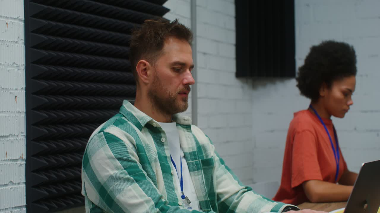 Coworkers working on laptops in a modern office