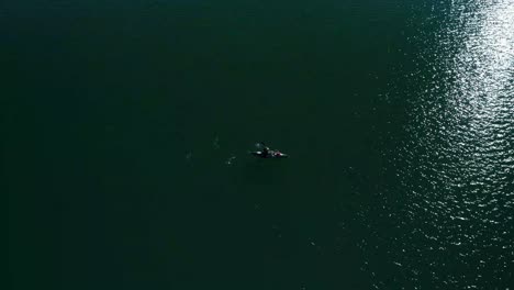 Water-surrounds-a-lone-kayak-rider-on-a-sunny-blue-skies-day