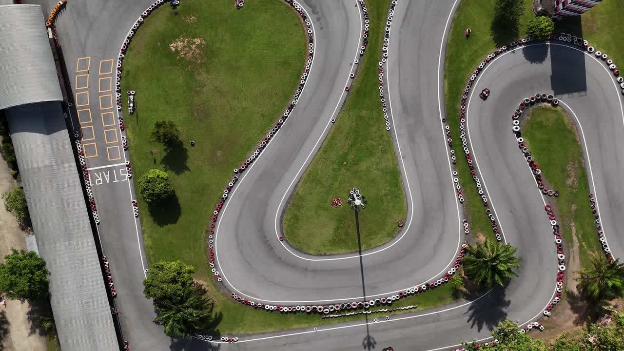 Overhead view of a go-kart track with tire barriers
